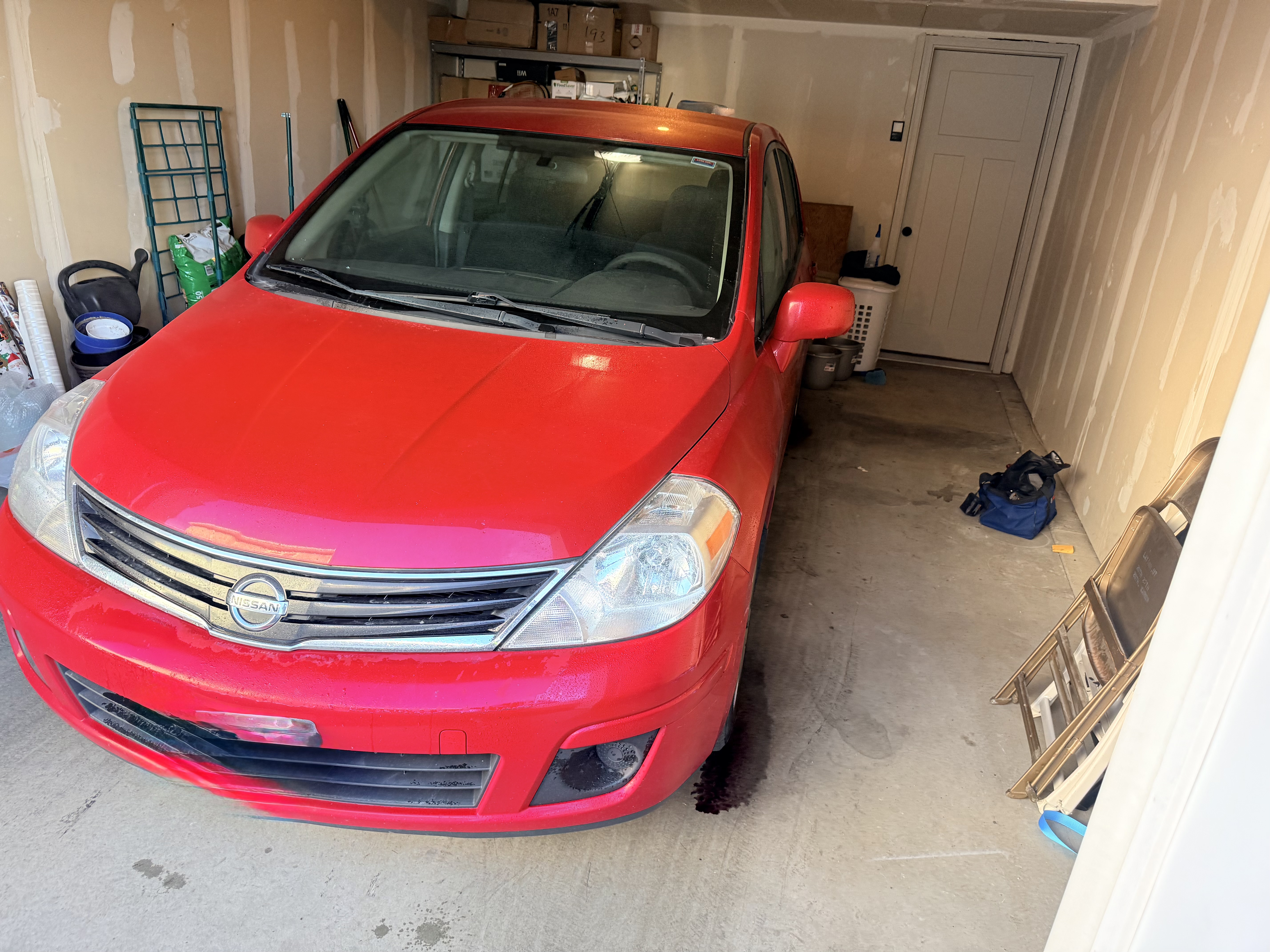 Red Nissan Versa before Platinum Graphene Gloss - front view