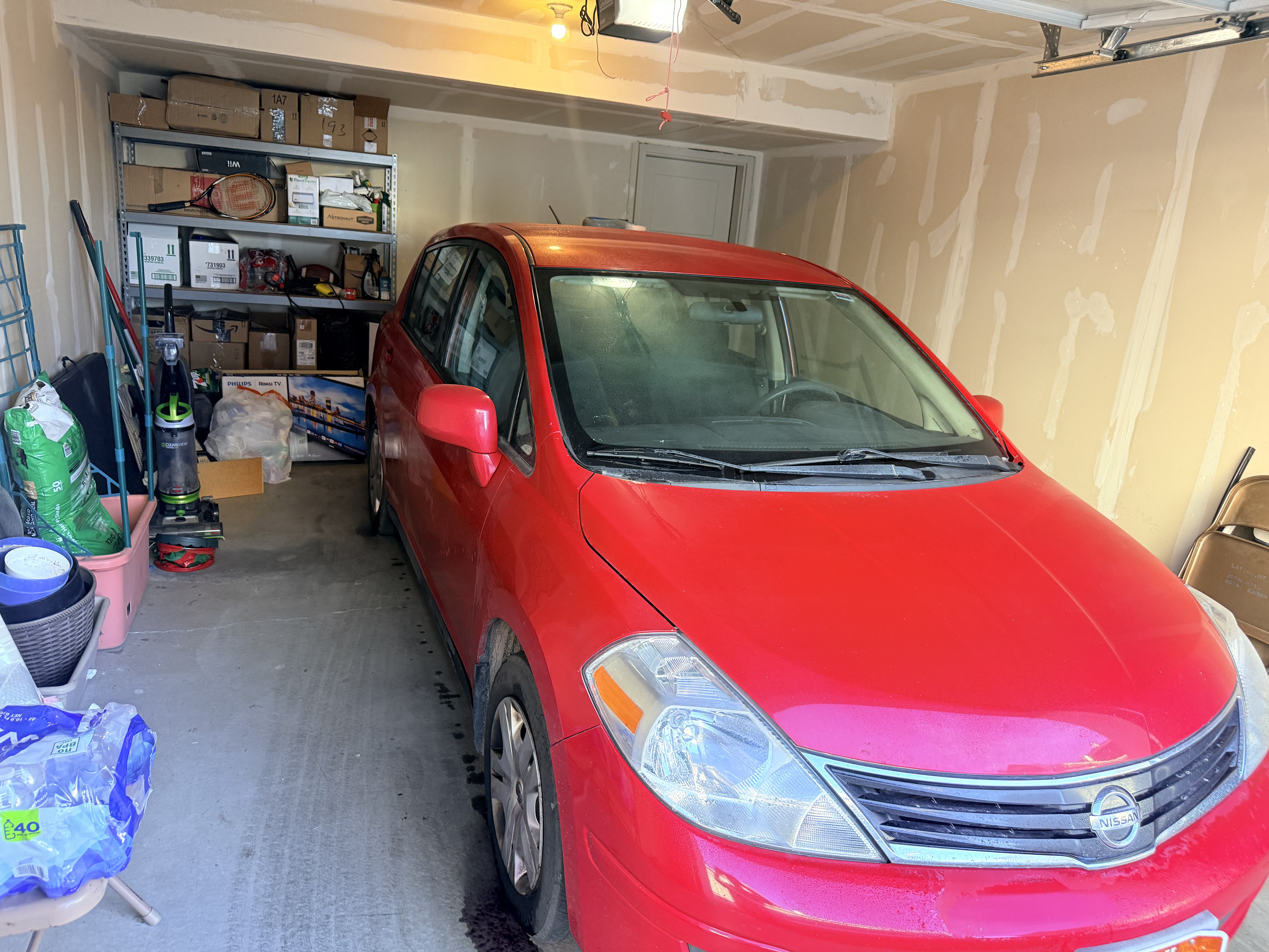 Red Nissan Versa before Platinum Graphene Gloss - side view