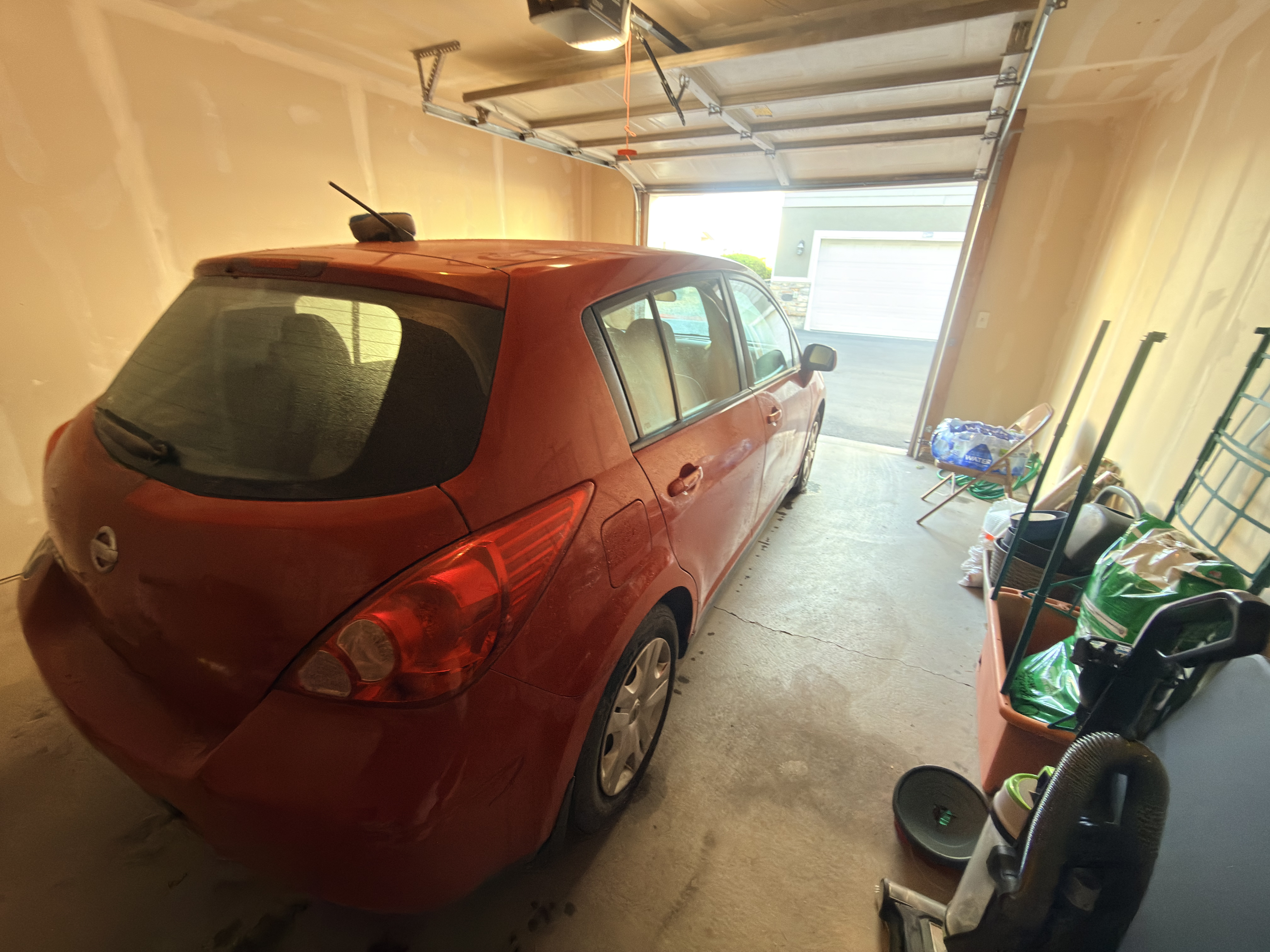 Red Nissan Versa before Platinum Graphene Gloss - rear view